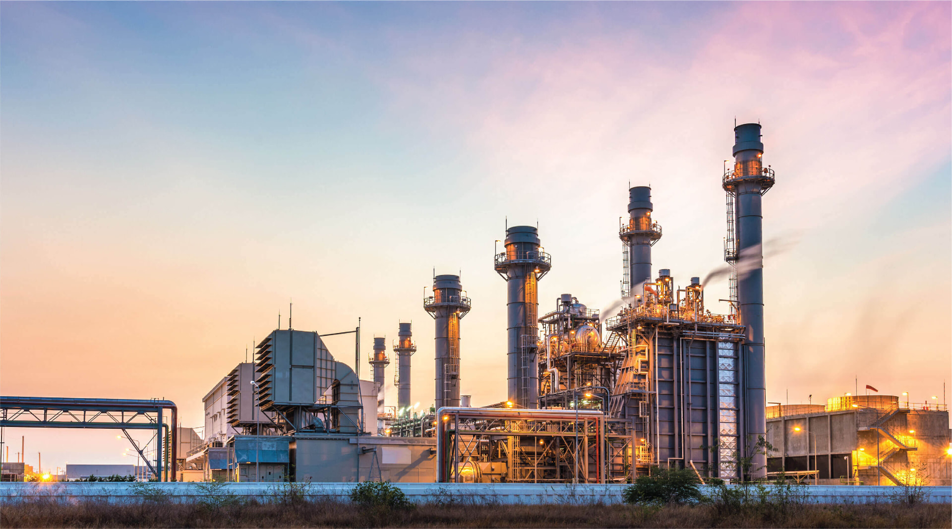 Petrochemical plant with stacks at sunset